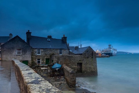 Lerwick, Shetland Islands, Scotland, UK. A traditional stone house at the sea near the port in