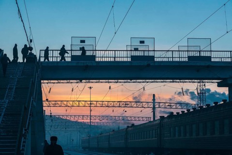 Siberia, Russia. People crossing a bridge at the train station near the Trans Siberian railway on