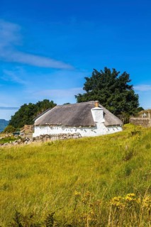 Isle of Skye, Scotland, UK. A traditional house across the meadows