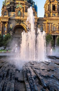 Water fountain, summer lifestyle, tourists and passers-by in the pleasure garden in Berlin-Mitte,