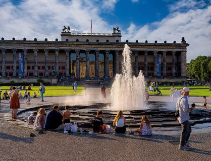 Water fountain, summer lifestyle, tourists and passers-by in the pleasure garden in Berlin-Mitte,