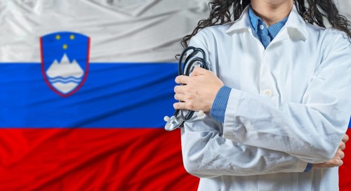 Healthcare professional with Slovenia flag background. Professional doctor holding stethoscope on