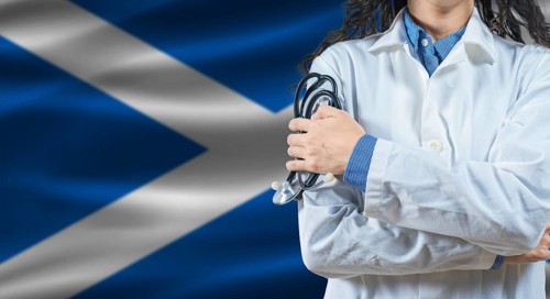 Healthcare professional with Scotland flag background. Professional doctor holding stethoscope on