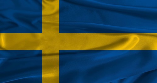Flag of Sweden with fabric textured background. Close up of National flag of Sweden with realistic