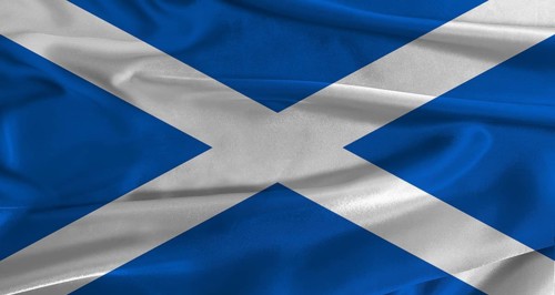 Flag of Scotland with fabric textured background. Close up of National flag of Scotland with