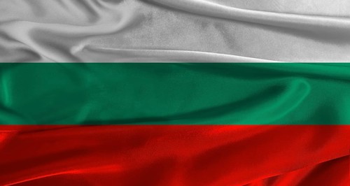 Flag of Bulgaria with fabric textured background. Close up of National flag of Bulgaria with
