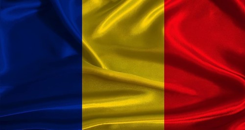 Romania flag with cloth textured background. National flag of Romania with realistic texture