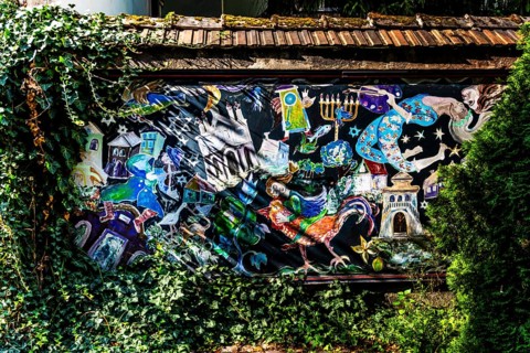 Street art on the wall of a building in the Kazimierz Jewish Quarter, a historically significant,