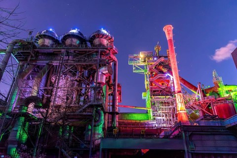Factory complex in colorful, lively lights under the night sky, Landschaftspark Duisburg Nord,