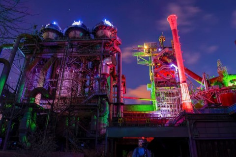 Industrial plant illuminated in colorful lights at night, Landschaftspark Duisburg Nord, Duisburg,