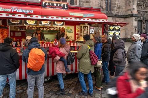 People waiting at the falafel stand in front of St. Lorenz Church, Nuremberg, Middle Franconia,