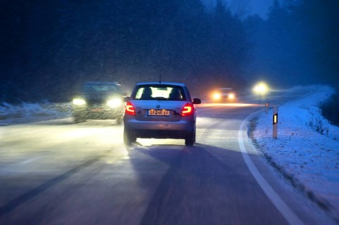 Cars during night snow flurries on B2, Heroldsberg, Middle Franconia, Bavaria, Germany