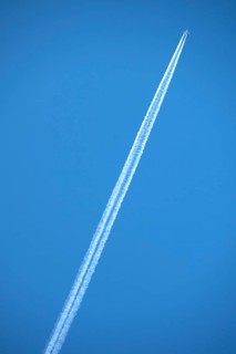 Airliner with contrails on blue sky, Bavaria, Germany