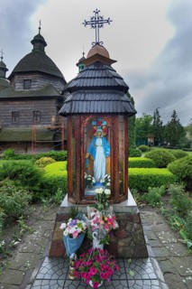 The Veneration of the Virgin in front of the historic, wooden Trinity Church, Zhovkva City, Ukraine