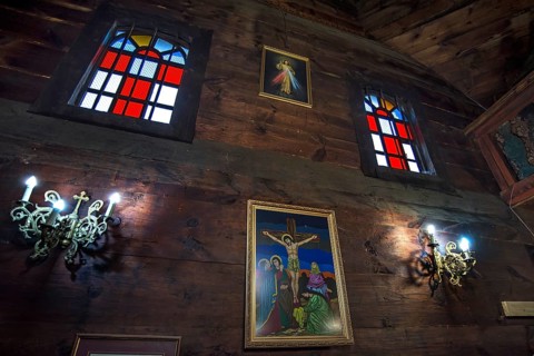 Colored stained glass windows in the historic wooden Trinity Church, Zhovkva city, Ukraine