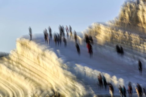 Terraced chalk cliffs Scala dei Turchi, anonymous walkers on Turkish steps, illustration, motion
