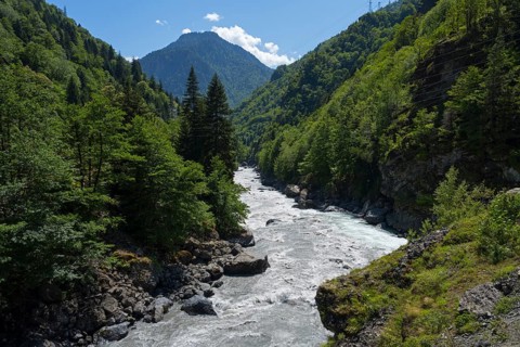 A picturesque river snakes through a wooded valley, Enguri River near Khaishi, Mingrelia region and