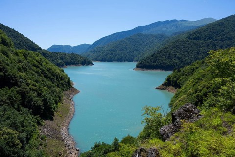 Clear mountain lake surrounded by wooded hills, Jvari Reservoir, Enguri River, Mingrelia and Upper