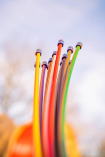 Close-up of colorful cables rising into the sky in sunshine, fiberglass groundbreaking,