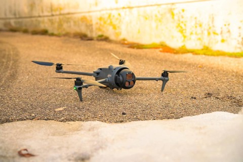 A black drone is lying on an asphalt path for outdoor use, fiberglass groundbreaking, Freudenstadt,