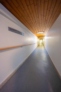 Long corridor with wooden ceiling and sign, soft lighting, fibreglass groundbreaking, Freudenstadt,