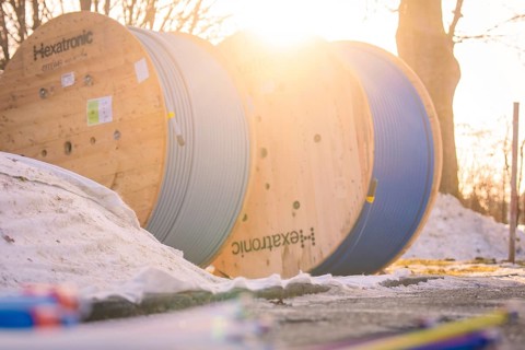 Cable drums in the snow, steeped in warm morning light, create a wintry atmosphere, fibreglass