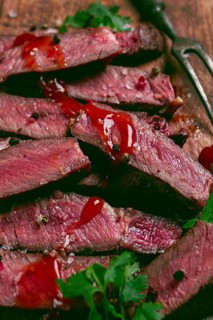 Fried steak, beef steak, rib eye steak, sliced steak, on a chopping board, top view, no people