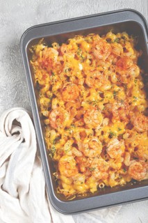 Pasta with shrimp and cheese, with a golden crust, cooked in a baking dish, homemade, no people