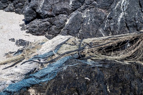 Close-up view of old fishing nets lying on the beach, Oman