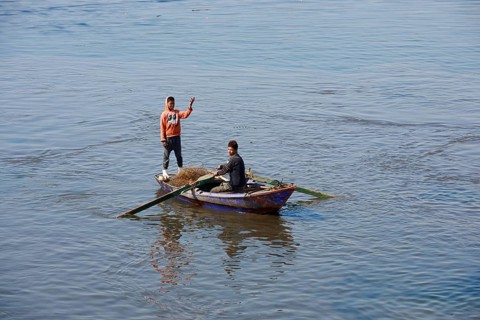 Boys in a rowboat fishing on the Nile, Luxor, Egypt