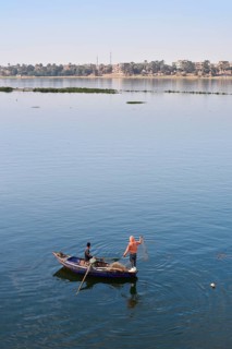 Boys in a rowboat fishing on the Nile, Luxor, Egypt