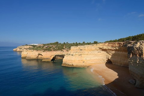 Cliff with caves and beach, Praia da Corredoura, Algarve, Portugal