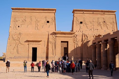 Tourists on the square in front of the first pylon, Isis temple, Philae temple, UNESCO World