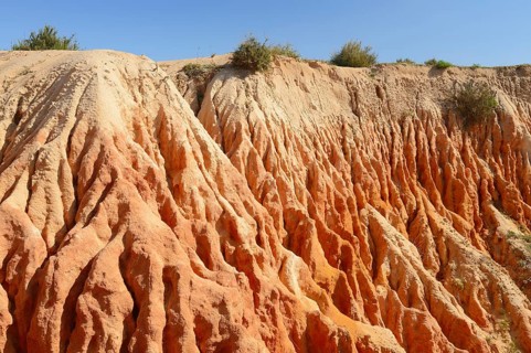 Eroded sandstone cliffs on the coast, Praia da Mesquita, Algarve, Portugal
