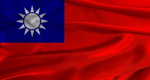 Flag of Taiwan with fabric textured background. Close up of National flag of Taiwan with realistic