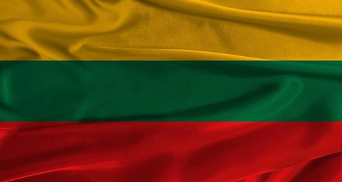 Flag of Lithuania with fabric textured background. Close up of National flag of Lithuania with