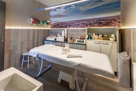 Beauty salon treatment room offering services for skin care, massage, and wellness, featuring a