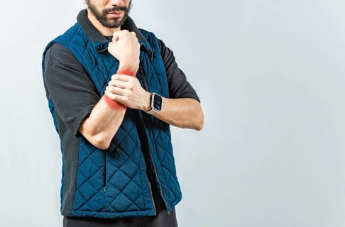 People with wrist pain isolated, Young man with pain in the hands, man with arthritis rubbing wrist