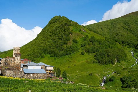 A green mountain with stone houses under a cloudy sky, defensive towers, Ushguli, Ushguli, Murqmeli