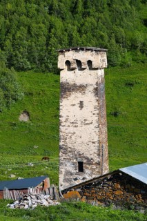 A single stone tower in a green mountainous landscape, defensive towers, Ushguli, Murqmeli