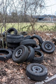 Illegally disposed of car tires and other trash, on a side street in Duisburg-Kaiserberg, North