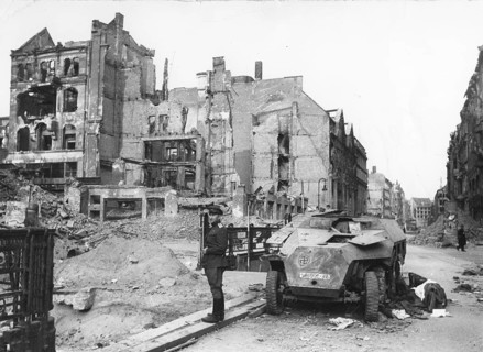 A Soviet soldier stands in front of destroyed residential buildings in Berlin, early May 1945