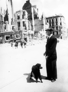 Civilians, man walking with dog (poodle) in the ruins of Berlin, June 1945, Berlin, Germany