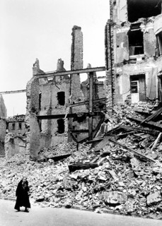 Civilians, an old woman in front of the rubble of a residential building, Berlin April 1945,