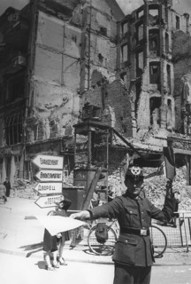 Traffic police officer in front of a destroyed residential building, Berlin June 1945, Germany