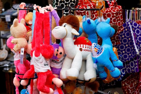 Sales stand with stuffed animals and other souvenirs for tourists at a market in Marrakech,