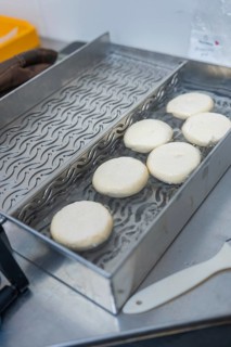 Round dough slices are on a tray ready for further processing, baking rolls, Haselstaller Hof,