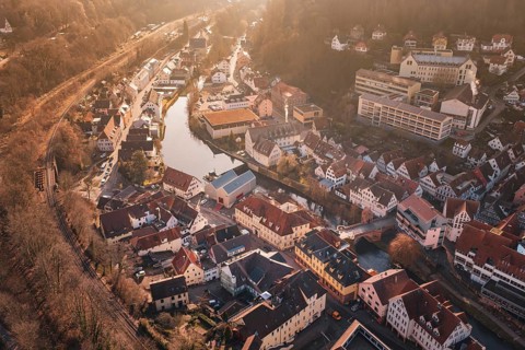 City view with river and buildings in sunlight from a bird's eye view, measurement trip on the new