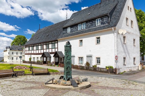 Market fountain with historical column on Bärenstein market square, Altenberg, Saxony, Germany