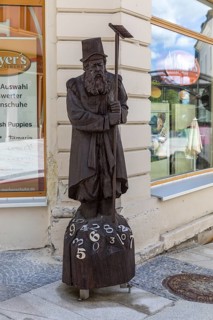 Wooden sculpture of Adam Ries as an arithmetic with numbers, signpost to the Adam Ries House and
